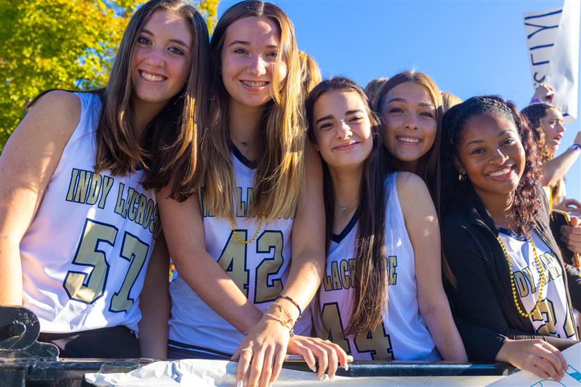 Students ride on a homecoming parade float